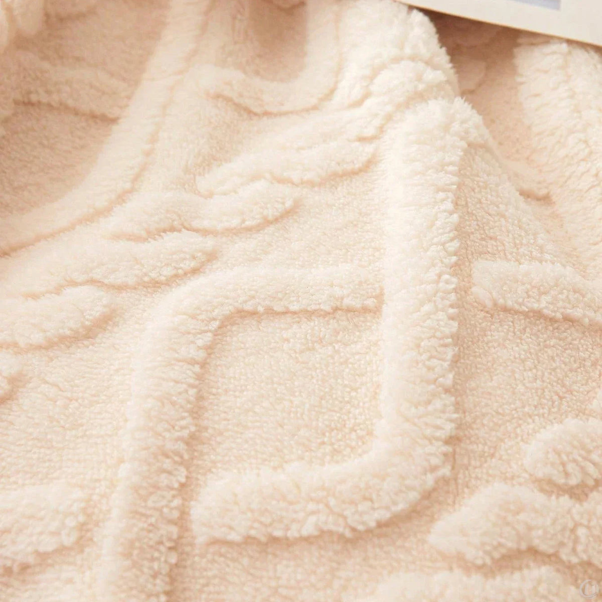 Close-up of the raised cable-knit pattern on the SNUG Traditional blanket